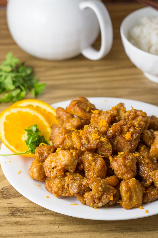 Orange Chicken served with orange slices and orange zest