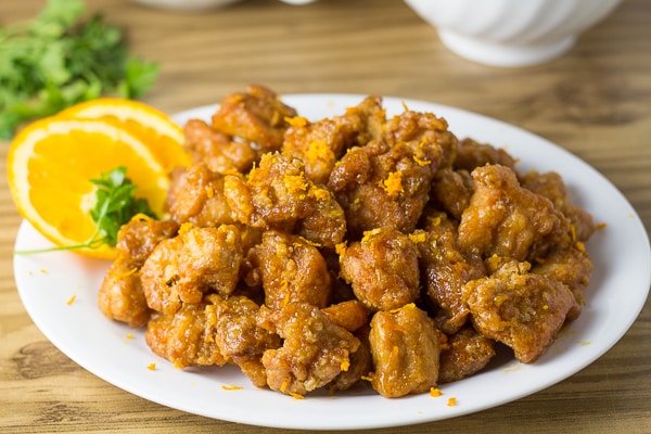 Orange Chicken served with orange slices and orange zest