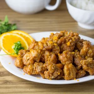 Orange Chicken served with orange slices and orange zest